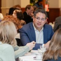 Attendee with glasses and blue blazer